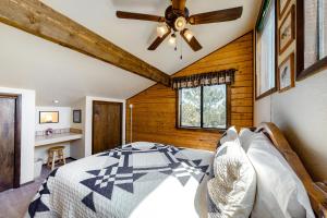 a bedroom with a bed and a ceiling fan at The Norma Charles in South Fork