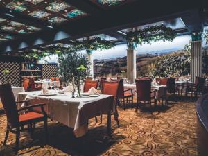 a dining room with tables and chairs with a view at Park, Hotel & Entertainment in Nova Gorica