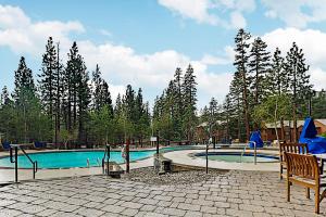 a large swimming pool with a chair and a table at Westin 617 in Mammoth Lakes