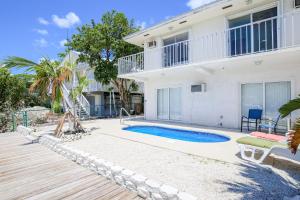 a villa with a swimming pool and a house at Marathon Memories in Marathon