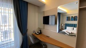 a hotel room with a mirror and a bed at Mithras Hotel in Izmir
