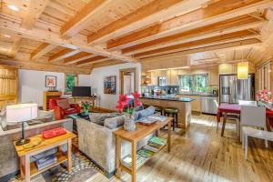 a living room and kitchen in a log cabin at Monte Rio Dream in Monte Rio
