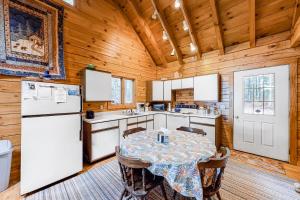 a kitchen with a table and a refrigerator at Lake View Cottage in Leeds