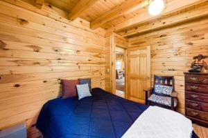 a bedroom with a bed in a log cabin at Lake View Cottage in Leeds