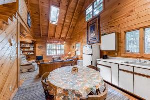 a kitchen and dining room with a table in a cabin at Lake View Cottage in Leeds