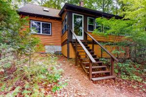 a tiny house with a staircase leading up to it at Lake View Cottage in Leeds