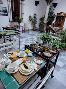 a table with plates of food on it at La Casa Grande in Arcos de la Frontera