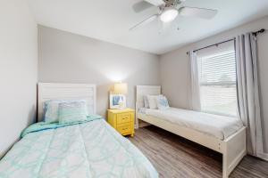 a bedroom with a bed and a window at Blue Haven in Panama City Beach