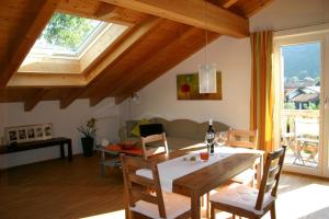 a dining room and living room with a table and chairs at Ferienwohnung Schmid Ursula in Kiefersfelden