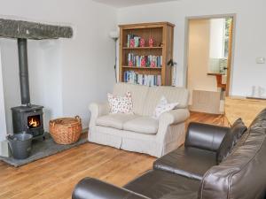 a living room with a couch and a fire place at 2 Farfield Row in Sedbergh