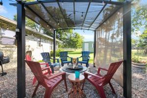 a patio with chairs and a table with a fire place at Wine’D Up in Fredericksburg