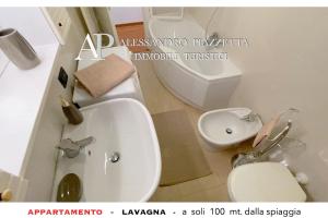 a bathroom with a white toilet and a sink at Lavagnacig in Lavagna +20 photos