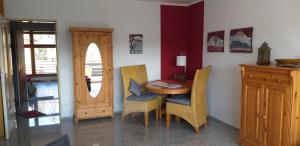 a dining room with a wooden table and chairs at Aussicht in Hahnenklee-Bockswiese