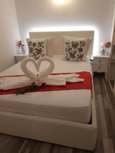 a bedroom with a bed with a heart decoration on it at Duplex Marquis in Braşov