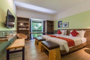a bedroom with a large bed and a television at Lamun at Canggu in Canggu +56 photos