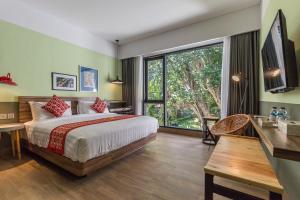 a bedroom with a large bed and a large window at Lamun at Canggu in Canggu