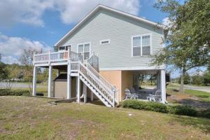 a house with a white deck and a porch at A Gift From Heaven in Oak Island