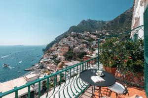 a balcony with a table and a view of the ocean at Alcione Residence in Positano