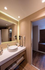 La salle de bains est pourvue d'un lavabo et d'un miroir. dans l'établissement Riva's Moda, à Istanbul
