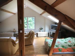 a living room with a couch and a fireplace at Maison de famille au plateau du Mezenc in Les Vastres
