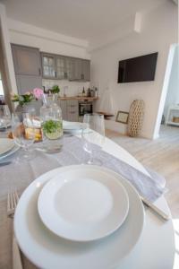 a table with a white plate and glasses on it at Apartment No4 in Stralsund