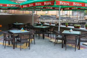 a group of tables and chairs with umbrellas in a restaurant at Hotel Terra in Gorna Oryakhovitsa