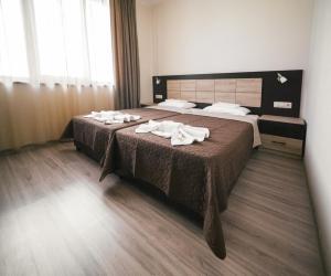2 łóżka w pokoju hotelowym z ręcznikami w obiekcie Hotel Terra w mieście Gorna Orjachowica