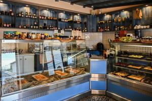 a bakery with a display case filled with lots of pastries at Vikos Hotel in Monodendri