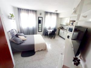 リョレート・デ・マルにあるEstudio Pazの小さなベッドルーム(ベッド1台付)、キッチンが備わります。