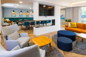 a waiting room with couches and chairs and a table at Staybridge Suites - Cardiff, an IHG Hotel in Cardiff