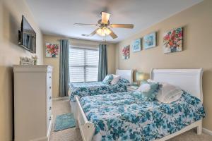 a bedroom with two beds and a ceiling fan at Macon Townhome with Patio, 5 Miles to Downtown! in Macon