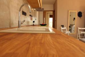 a kitchen with a wooden counter top with a sink at Horizonte Seafront Suites in Kissamos