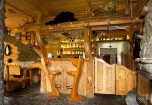 un bar en una cabaña con paredes de madera en Pensjonat u Ani, en Zakopane