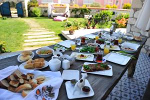 a table with plates of food on top of it at Alaçatı Sultan Konak Butik Otel ℳℛ Luxury Concept in Alacati