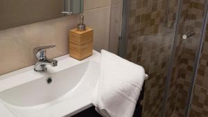 a bathroom with a sink and a shower at Breathe In in Zambujeira do Mar