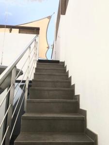 a set of stairs in a building with the sky in the background at Casa dos Retratos Faro in Faro