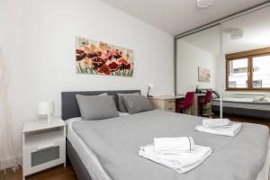 a bedroom with a bed with two towels on it at Zemun Luxury - Comfortable, workspace, quiet, free parking, Netflix in Belgrade