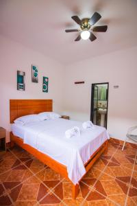 a bedroom with a bed and a ceiling fan at HOSPEDAJE SANTA MONICA in Tarapoto