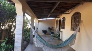 a hammock on the porch of a house at Aluga-se casa perto da orla para temporada. in Alcobaça