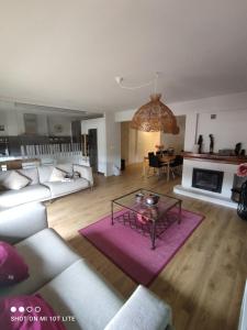 a living room with a couch and a table at Un balcón sobre el Rio Sella in Ribadesella