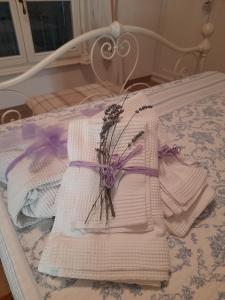 a pile of towels and flowers on a bed at Villa la provenzale in Camaiore +39 photos