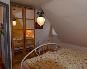 a bedroom with a bed and a room with two beds at Ferien unterm Reetdach Whg 01 in Oevenum