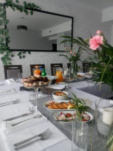 a table with plates of food on it at Kresovia in Biłgoraj