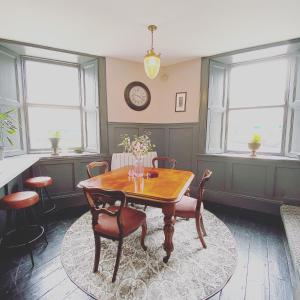 a dining room with a wooden table and chairs at No. 1 Bridge Street in Westport