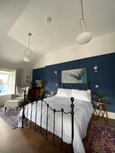 a bedroom with a bed and a blue wall at No. 1 Bridge Street in Westport