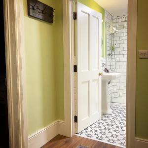 a bathroom with a white door and a sink at No. 1 Bridge Street in Westport +30 photos