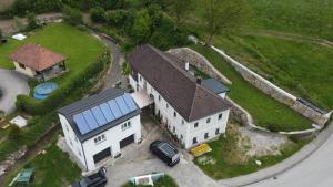 an aerial view of a white house with a roof at Haus am Bächle in Stephanshart