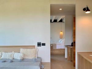 a bedroom and a living room with a couch and a kitchen at Santa Lucia Maccarese - Residenza Agricola in Maccarese