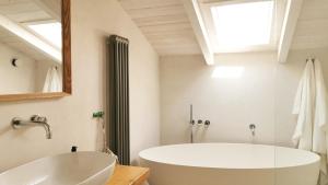 a bathroom with a white tub and a mirror at Santa Lucia Maccarese - Residenza Agricola in Maccarese