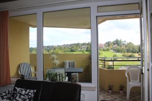 a living room with a sliding glass door with a view at Harz-Fewo KY487 in Braunlage